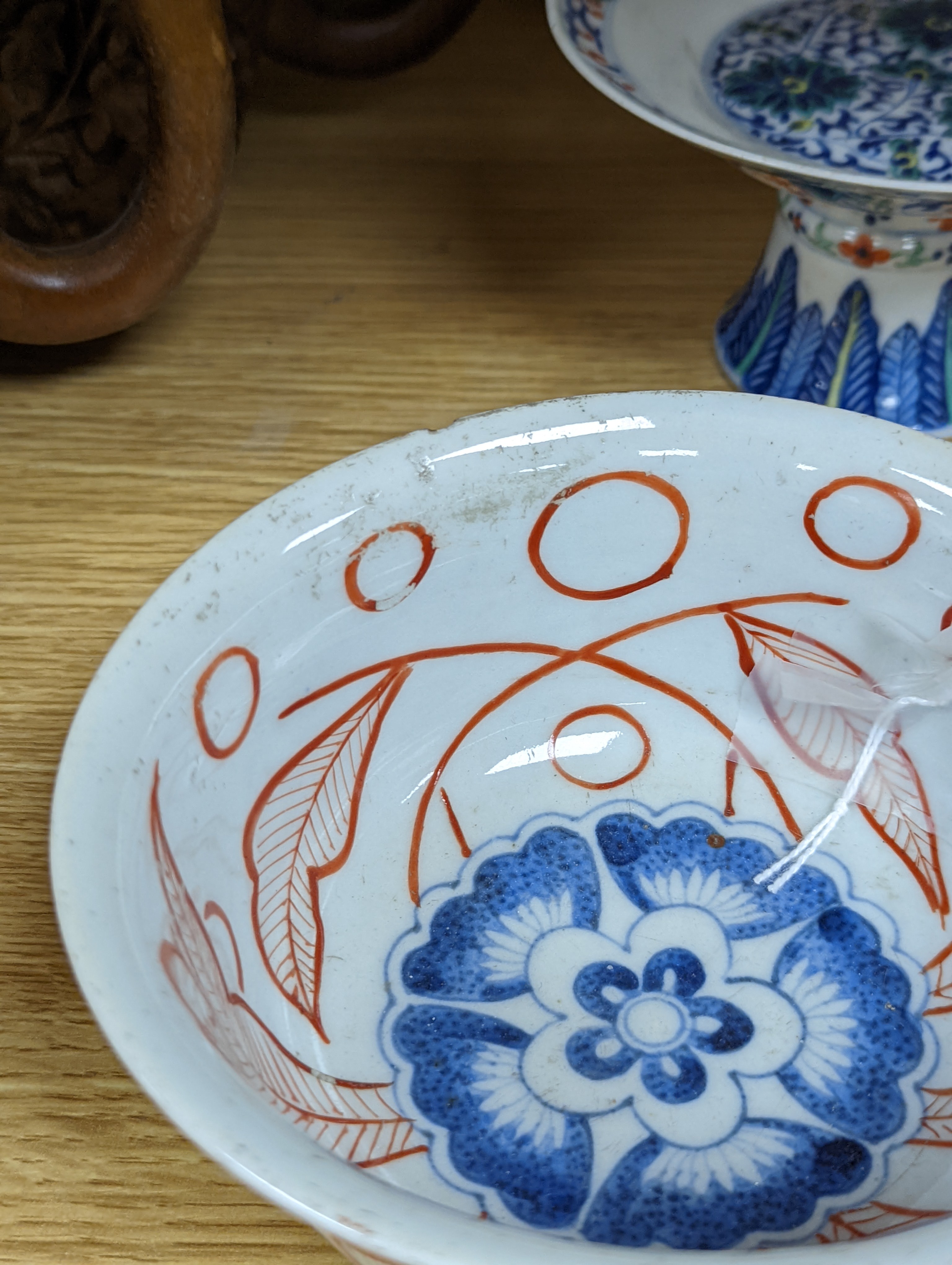 A Chinese blue and white water pipe vessel, a doucai stem dish and a Japanese Imari bowl, 19th century, (3)
